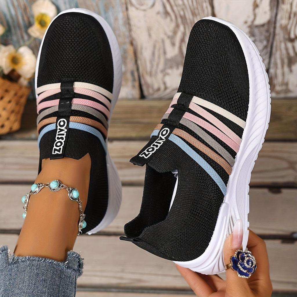 The Lady Wears Slip-On Casual Sports Shoes, Featuring a Breathable Mesh Design with Pastel Stripes, Suitable for Tennis And Comfortable