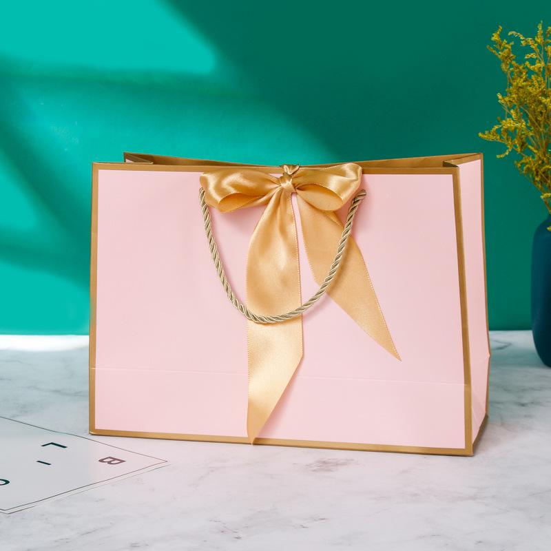 In-Stock White Cardboard Gift Bags with Bow Handle, Customizable Logo for Clothing Stores