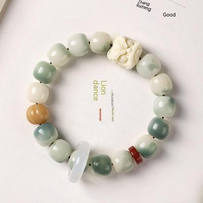 Pulsera de raíz de Bodhi de jade blanco degradado de león que despierta la fruta de marfil con caja de regalo