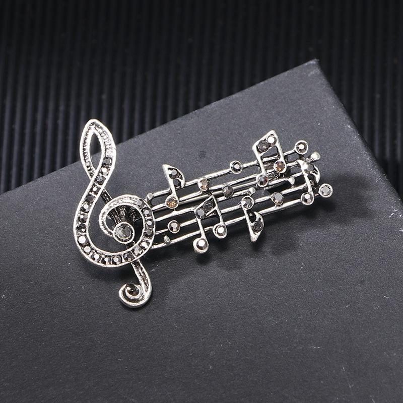 Spring and summer new alloy diamond music symbol brooch femininity high sense fashion music note clothing corsage