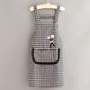 Black And White Checkered Apron With Cute Flower Decorations And Large Pockets.
