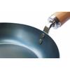 This 24cm iron skillet with a plain wood handle is made in Japan and is suitable for induction cooktops. It's lightweight and requires no seasoning. P