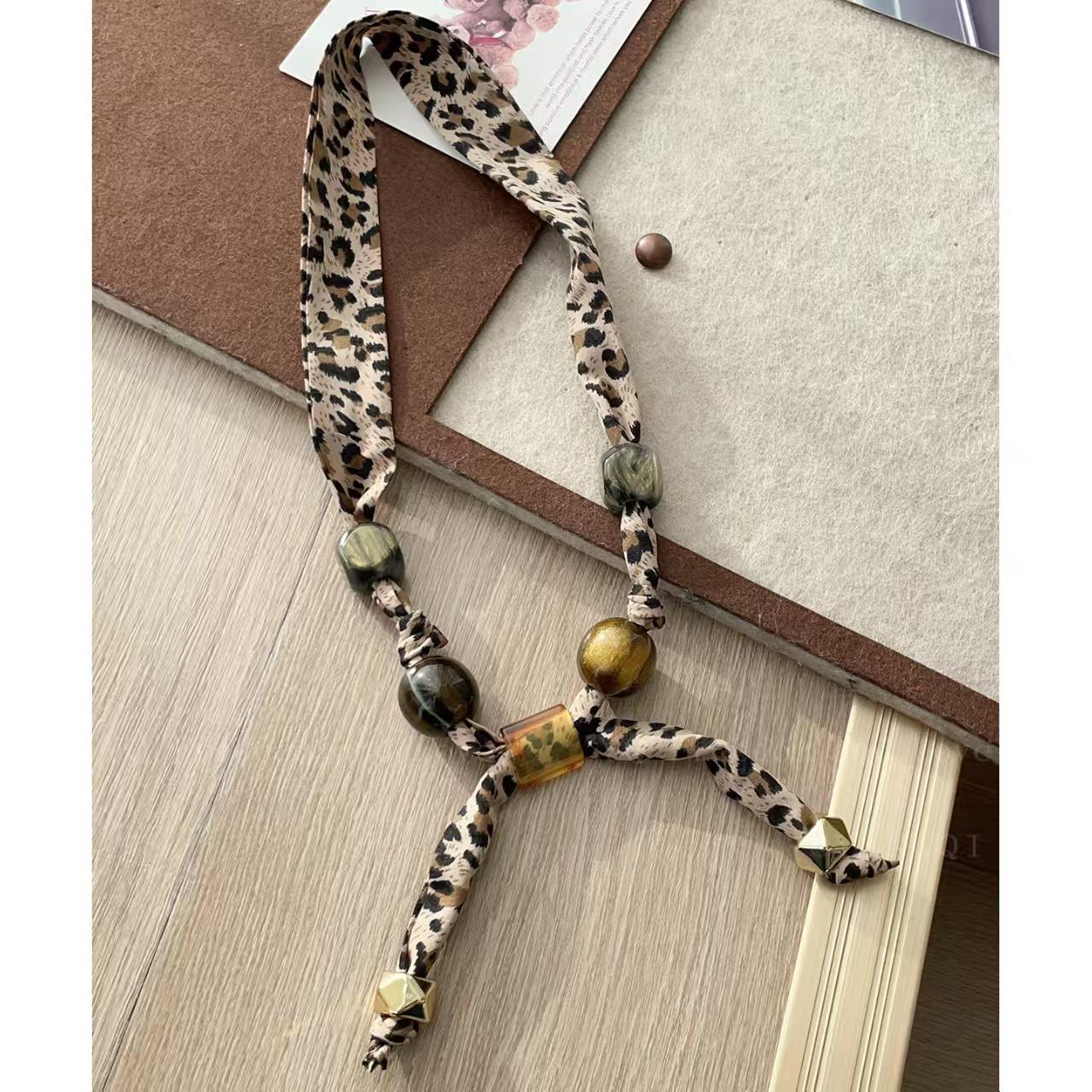

Жіночий шовковий шарф-намисто Meillard з леопардовим принтом, тканинною квіткою та унікальним дизайном на шнурку