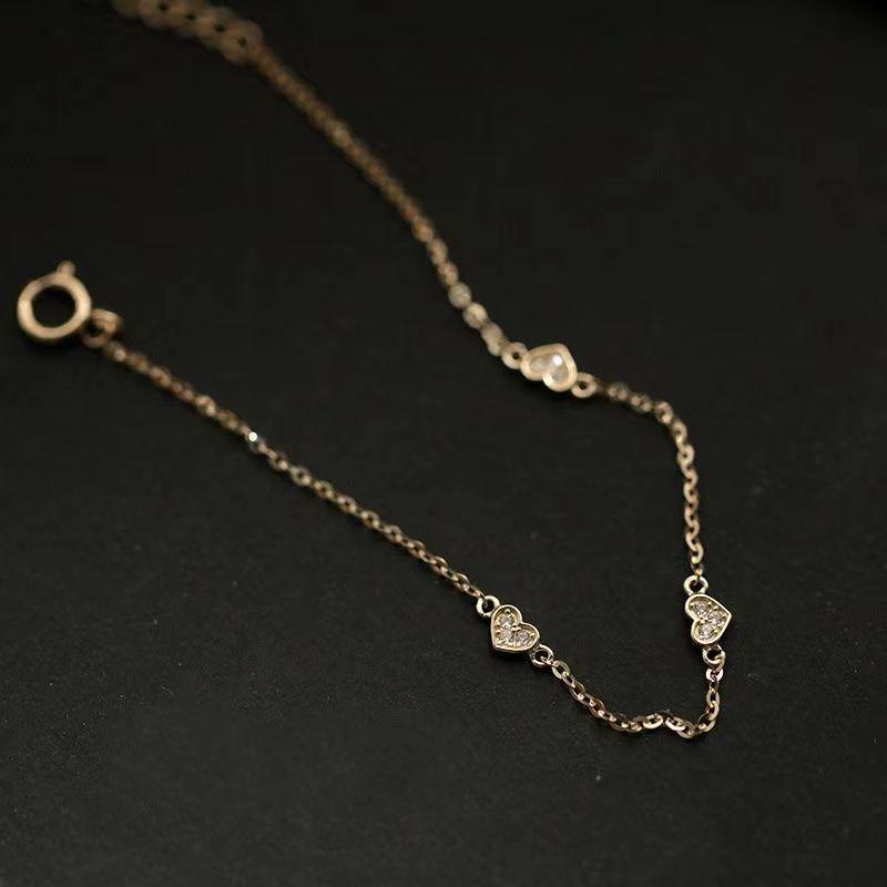 Japanese S925 Sterling Silver Heart-Shaped Bracelet with 14k Gold Plating, Featuring Three Small Cold Style Hearts. Simple and Elegant Design.