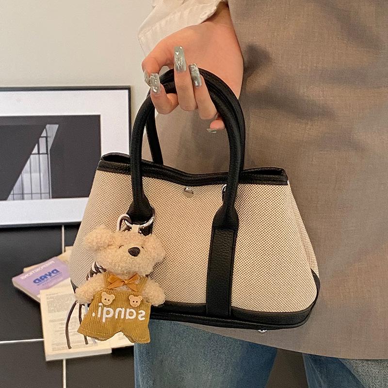 Korean version of casual niche contrasting color splicing portable bucket bag fashion versatile temperament casual commuter messenger bag woman