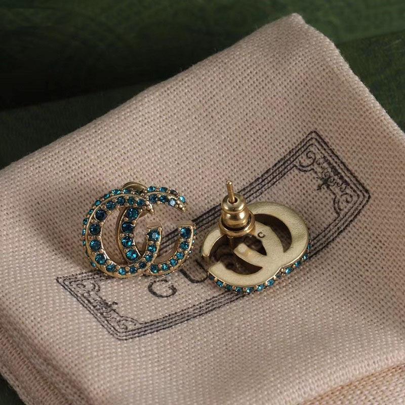 Gu Jia Doppeltes G Blaue Strass-Steckohrringe - Vintage Messing-Design mit Silbernadel