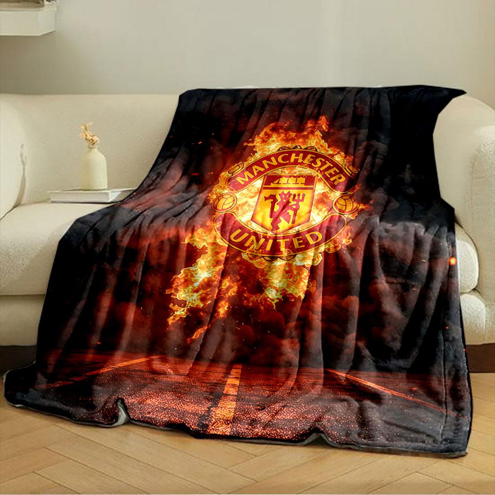 A Fiery Manchester United Logo Emerges Against Smoke and a Dark Background. for All Seasons Blanket Lunch Break Throw Gift