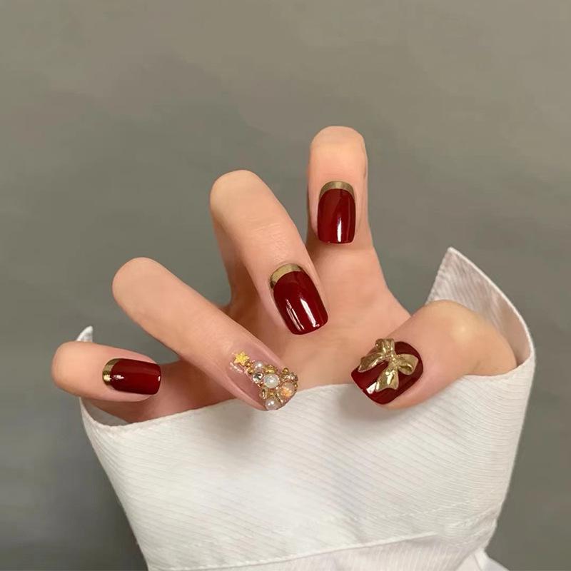

Burgundy Gold-Edged Press-On Nails with Bow and Christmas Tree Design